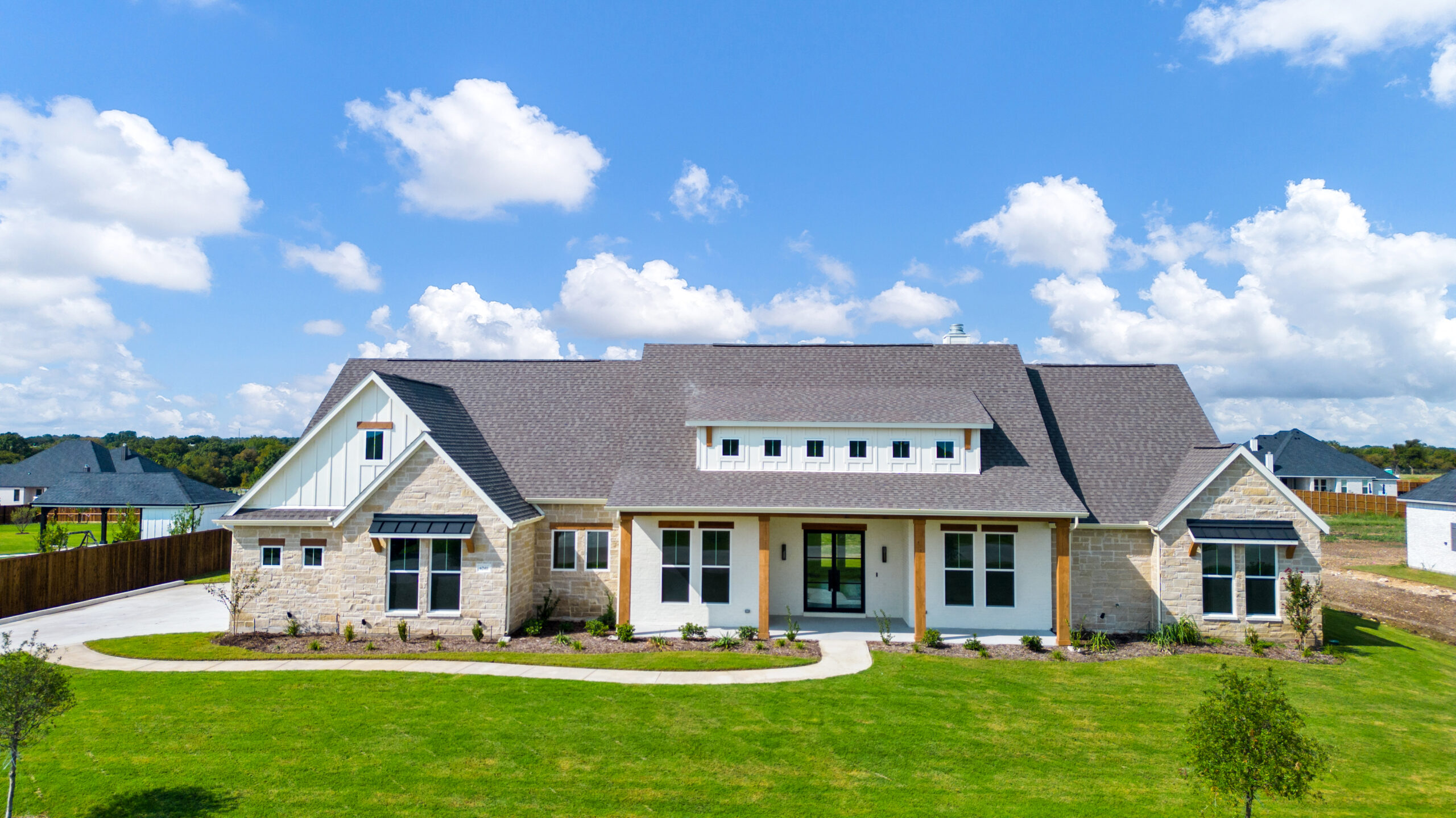 Front exterior of a new single-story home on a large lot