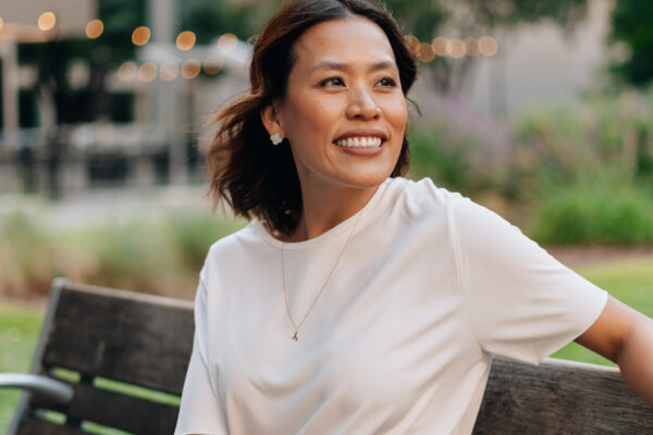 Branding portrait of a smiling woman seated outdoors