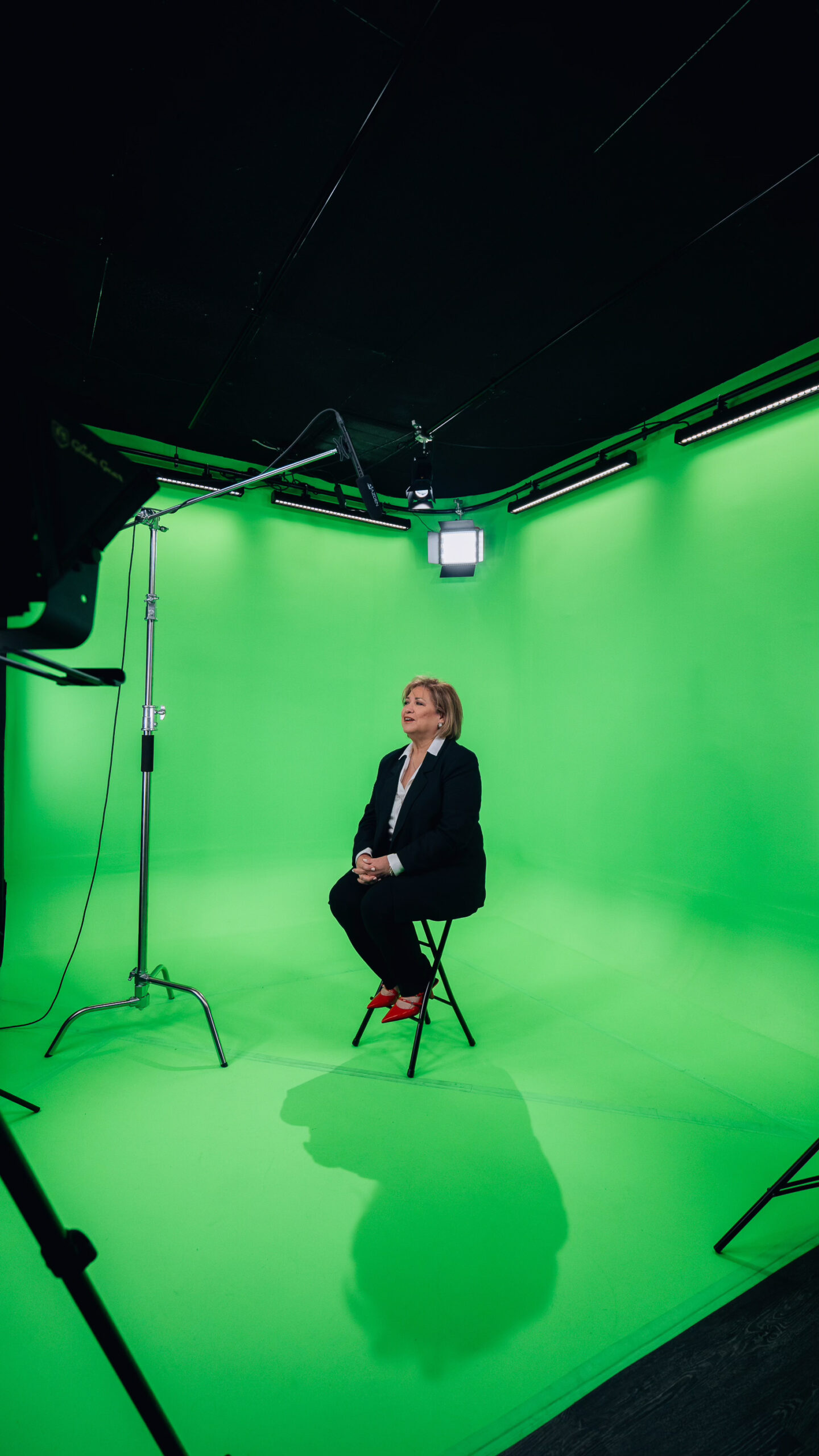 Interview subject seated on the green screen stage