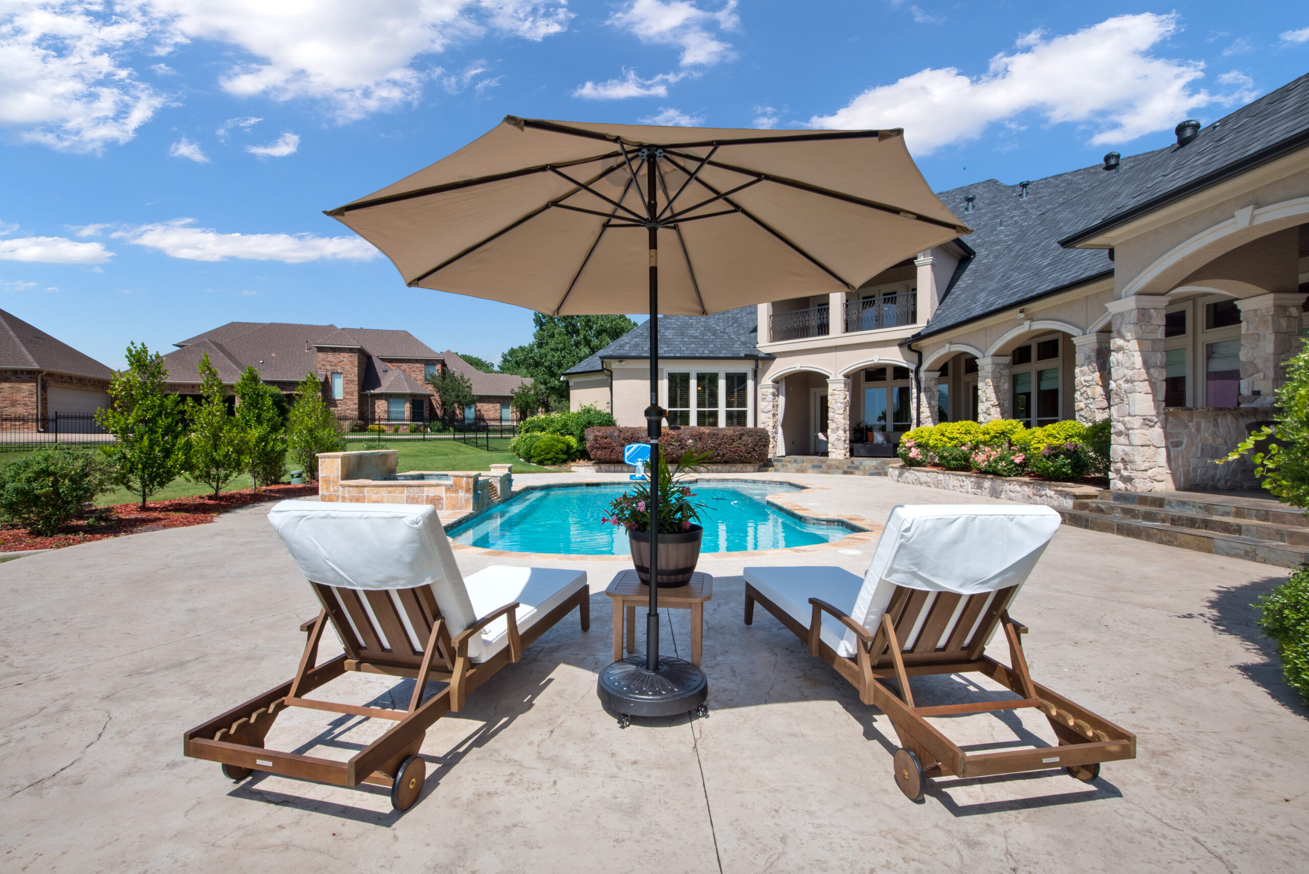 Pool deck with lounge chairs and an umbrella
