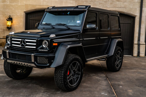 Black SUV parked in front of a garage