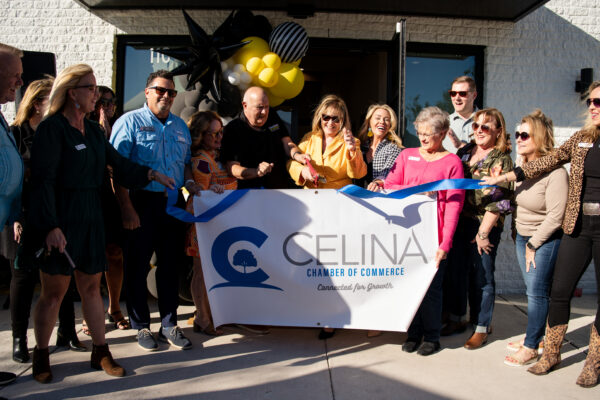 Chamber of commerce ribbon cutting with a crowd