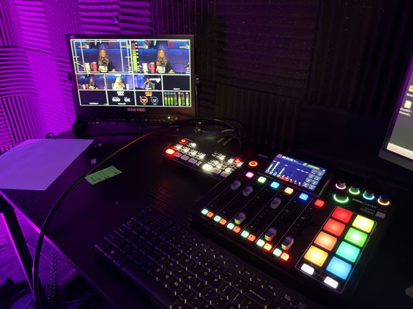 Audio console and program monitor in the Plano podcast studio at studioUSA East